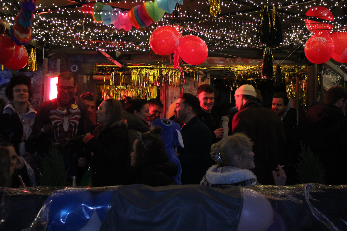 Faschingsstimmung in der Boazn München mit roten Luftballons und Lichterketten — Karneval 2025 an der Isar