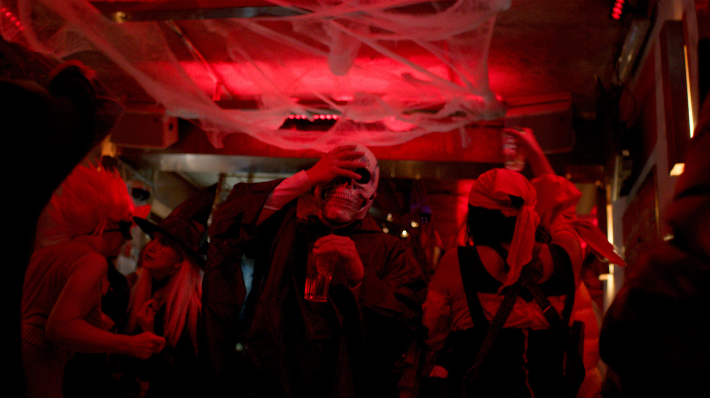 Gast schiebt seine Totenkopfmaske hoch, Spinnweben an der Decke – Halloween 2025 in der Boazn München 8