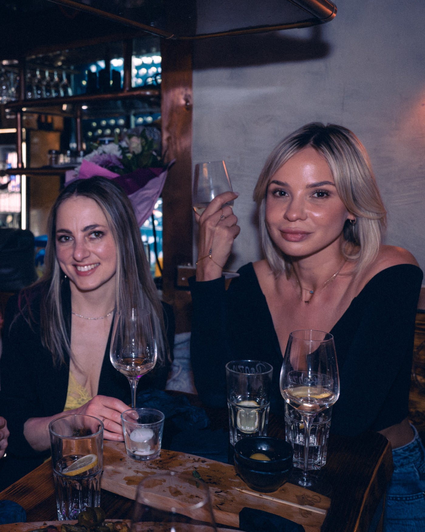 Zwei Frauen stoßen mit Weißweingläsern an der Bar an – Boazn München, Tanzbar an der Ludwigsbrücke, April 2026 7